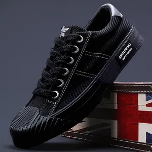 Classic black men's casual canvas sneakers with textured rubber toe cap and flat sole