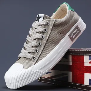 Stylish grey canvas sneakers with white rubber toe caps and soles for casual men's fashion