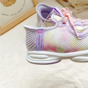 Close-up of pastel rainbow mesh kids sneakers with walk on water pull tab detail.