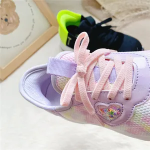 Detailed macro view of pink laces and heart star glitter on purple breathable kids sneakers