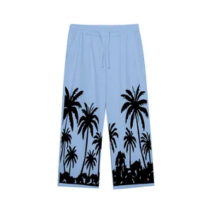 Detailed view of men's light blue casual straight trousers featuring black Hawaiian palm tree prints