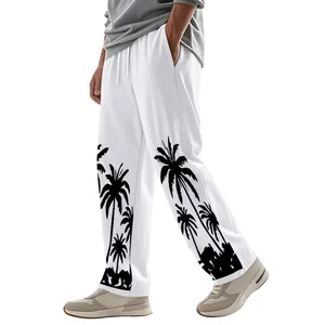 Close-up detail of men's white linen trousers featuring a black Hawaii palm tree print
