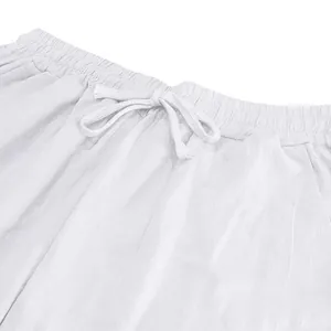 Close-up detail of the elastic drawstring waistband on white breathable linen leisure pants