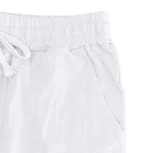 Close-up of white linen pants featuring elastic waistband with adjustable drawstring