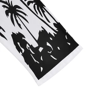 Detailed macro view of black palm tree and mountain print on white linen fabric texture