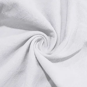 Detailed close-up showing the soft breathable texture of white linen fabric for men.