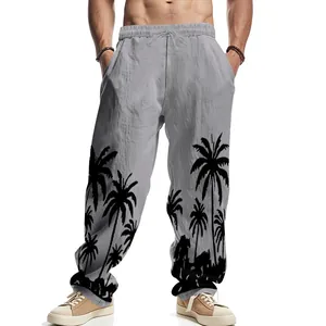 Detail view of men's linen pants featuring black palm tree prints on light gray fabric