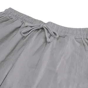 Close-up of grey linen trousers waistband with elastic band and adjustable drawstring