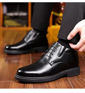 Detail of black men's winter business leather shoes with lace-up design and warm lining.