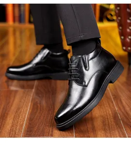 Detailed macro view showing the textured pattern of black leather high-top business shoes for men