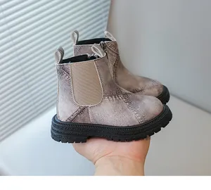 Detail view of children's washed denim ankle boots featuring side zipper and thick soles