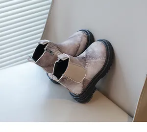 Detail of children's Martin boots featuring distressed denim texture and zipper.