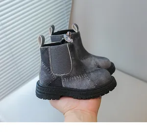 Close-up view of grey denim-textured kids martin boots with anti-slip thick soles