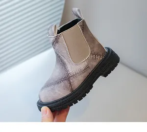 Detailed side view of a girls' British style Martin boot featuring denim texture and lug sole