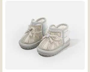 Detailed view of baby girl winter snow boots with elegant pearl and bow decorations