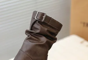 Vue détaillée de bottes mi-mollet marron pour enfants avec boucle et design plissé
