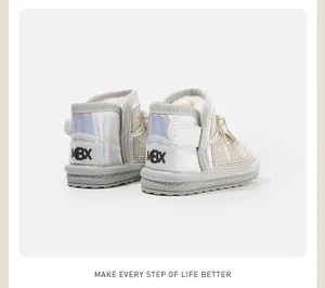 Close-up of warm white baby girl snow boots featuring iridescent heels and pearl decorations