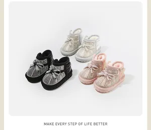 Detailed view of baby girl winter snow boots with pearl and rhinestone bow in multiple colors