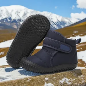 Detail of children's navy blue snow boots featuring a thick warm lining and anti-slip sole