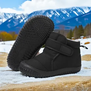 Detail view of black children's waterproof snow boots with warm lining and anti-slip sole
