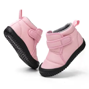 Detail of pink children's winter snow boots with fleece lining and velcro straps