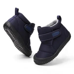 Close-up detail of navy blue children's winter snow boots with warm fleece lining