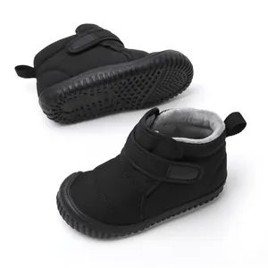 Close-up view of black children's winter snow boots with thick warm fleece lining