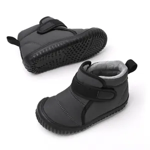 Detailed view of grey children's snow boots with warm plush lining and Velcro strap.