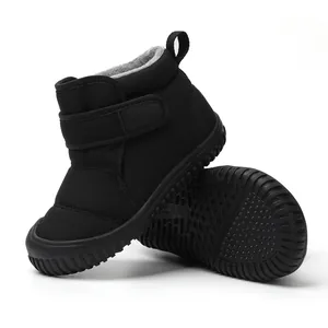 Detail view of black children's winter boots with warm fleece lining and non-slip sole.
