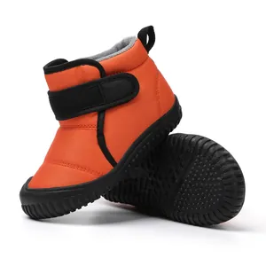Orange fleece-lined children's snow boots with Velcro straps and anti-slip soles
