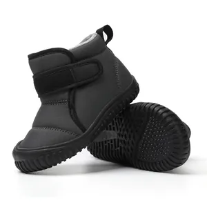 Detailed view of children's warm grey winter snow boots with textured rubber sole
