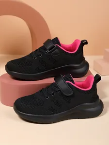 Detailed view of girls' black breathable mesh running shoes with vibrant pink inner lining.
