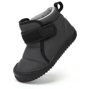 Detailed macro view of warm fleece-lined winter snow boot for kids in a dark grey finish