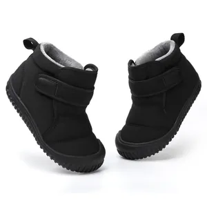 Close-up detail of black children's snow boots featuring warm fleece lining and Velcro