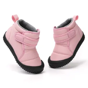 Pair of pink children's waterproof winter snow boots with warm fleece lining and Velcro strap
