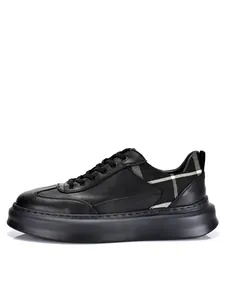 Side view of premium black leather platform sneaker featuring a stylish monochromatic plaid pattern