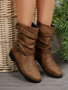 Side view of brown mid-calf western boots with buckle straps and slouchy texture