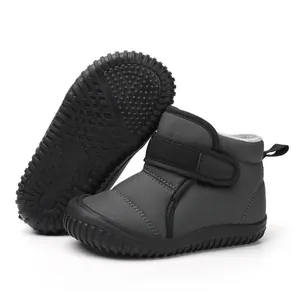 Close-up of children's grey snow boots showing non-slip sole and warm plush lining