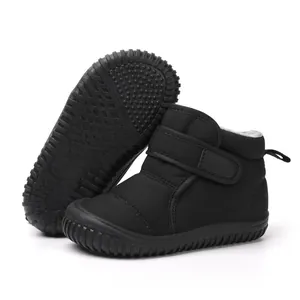 Detail view of black children's snow boots with Velcro strap and non-slip rubber sole