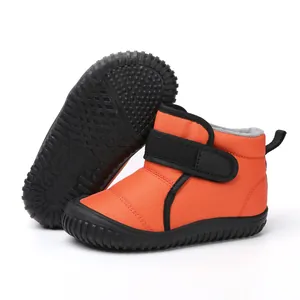 Warm orange children's snow boots with durable non-slip sole and thick fleece lining