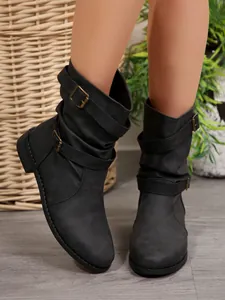 Close-up of black Western mid-calf boots with triple buckle straps and matte finish.