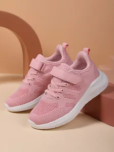 Side view of breathable pink mesh sneakers for girls with thick durable white soles