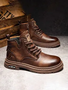 Macro view of men's retro brown leather Martin boots featuring rugged sole and side zipper