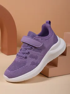 Close-up of purple mesh breathable sneakers for girls with velcro strap and white sole