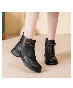 Side view of elegant black leather ankle boots with decorative knot detail