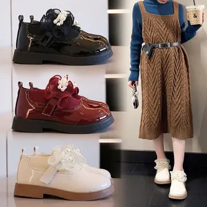 Three colors of girls' patent leather Mary Janes with pearl floral accents and sock cuffs