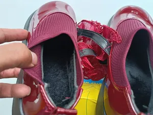 Detailed view of the warm black fleece lining inside girls' burgundy patent leather shoes