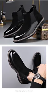 Close-up of men's black Chelsea boots with leather and suede splicing detail