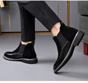 Detail of men's black Chelsea boots featuring a stylish leather and suede splice