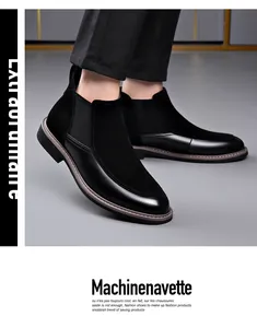 Close-up detail view of men's black Chelsea boots with leather and suede splicing design
